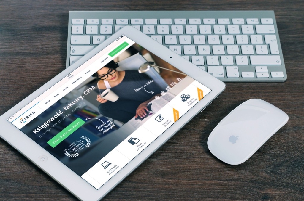 Responsive web interface shown on tablet device alongside modern desktop accessories